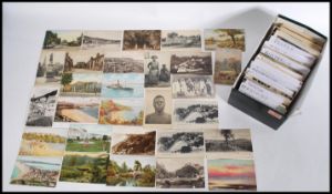 A shoe box of approximately 400 vintage postcards dating from the early 20th century to include