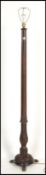 A good 19th century solid mahogany standard lamp of reeded form being raised on terraced base with