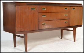 A vintage / retro 20th Century teak wood sideboard / credenza, central bank of three drawers flanked