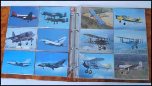 A collection of 200 plus aviation related postcards held within an album. Album 35cm-high 36cm-wide.