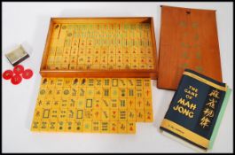 A vintage 20th century Mahjong gaming set, having 152 yellow plastic / Lucite pieces bearing