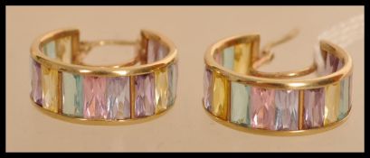 A pair of hallmarked 9ct gold hoop earrings set with pastel coloured stones. Hallmarked Sheffield.