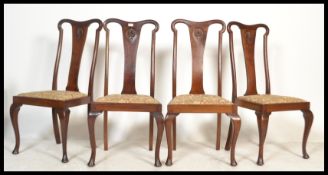 A set of 4 Edwardian mahogany Queen Anne high back dining chairs being raised on cabriole legs