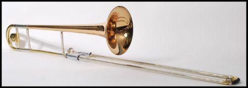 A 20th Century cased Frank Holton & Co Collegiate brass and plated trombone, engraved Holton Elkhorn