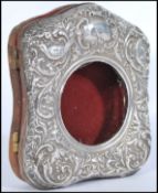 An early 20th century silver hallmarked pocket watch stand having an easel back with hinged side