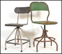Two vintage mid 20th Century industrial machine st swivel chairs, the chairs raised on tubular