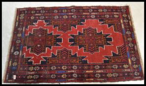 A vintage 20th Century Persian / Islamic woven woollen floor rug on blue ground decorated with