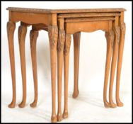 A set of three graduating vintage walnut nest of tables, raised on cabriole supports with drop in