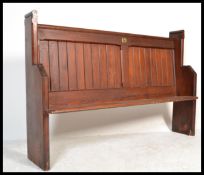 A 19th century pitch pine ecclesiastical church pew of shaped form being of small proportions. The