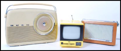 A vintage retro 20th century small portable TV television in a vibrant yellow colourway along with