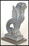 A 20th Century reconstituted stone garden ornament in the form of a Griffin, raised on a slate