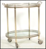 A vintage 20th century silver white metal hostess trolley, with detachable glass bottomed, twin