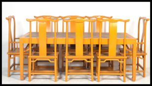 A large Chinese refectory dining table and chairs suite, the large painted table having a rattan