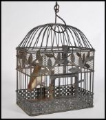 A charming vintage 20th century wire work bird cage having a domed top with hook atop. Complete with