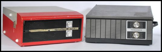 Two vintage 20th Century portable record players, both with hinged tops, carry handles to the