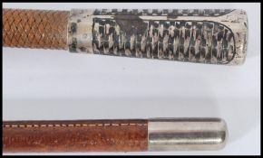 Two vintage early 20th century riding whip crops one having a silver end with woven design.