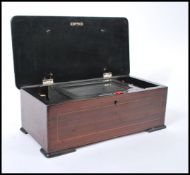 A 19th century rosewood music cylinder box having a hinged lid opening to reveal a glazed panel with