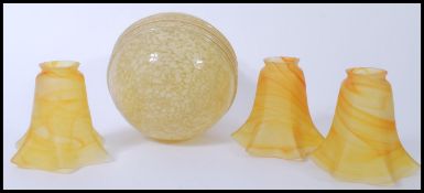 A group of retro vintage 20th century lamp shades to include a yellow mottled glass spherical lamp