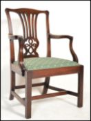 A George III 18th century mahogany Chippendale revival desk chair being raised on squared legs