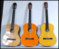 A group of three acoustic six string guitars to include a Burswood, Palencia and another. Average