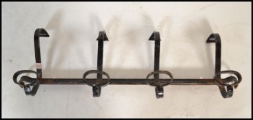 A set of vintage early 20th Century wall hanging coat hooks, each hook having a large and small hook
