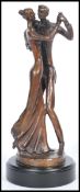 Bernard Kim (b.1942) A bronze statue figurine featuring a dancing couple raised on pedestal base.