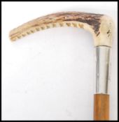 A 19th Century wooden horn handled riding whip having a silver hallmarked collar and leather lash.