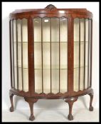A 1930's mahogany Queen Anne revival demi-lune china display cabinet. Raised on cabriole legs with