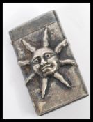 A silver plated vesta case having embossed decoration in the form of a sun. Weight 36.2g.