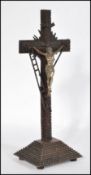 A contemporary tramp / outsider art geometric carved wood crucifix sculpture depicting the