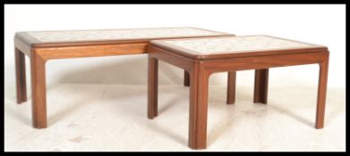 A mid century teak wood and tile top coffee table of rectangular form together with a smaller teak