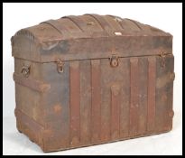 A late 19th Century dome topped metal mounted trunk chest, paper lined to the interior, with lock to