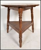 A vintage 20th Century pine tavern table, circular top raised on tripod three tuned supports