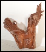A 20th century teak wood carved statue of a posed