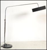 A vintage 20th century tubular angled lamp raised on a black marble circular base with adjustable