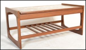 A 1970's teak wood and tile top retro coffee - occasional table being raised on squared legs with