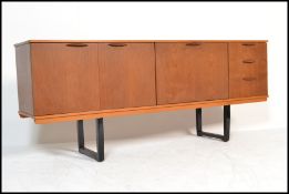 A vintage retro 20th Century teak wood sideboard / credenza, having bi - fold doors nest to fall