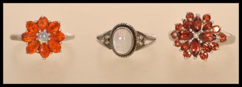 A selection of silver rings to include a stamped 925 flower head cluster ring (size O.5), a