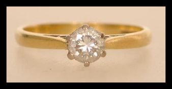 A hallmarked 18ct gold diamond solitaire ring having a central brilliant cut stone of approx