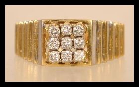 A hallmarked Art Deco Style 18ct gold and diamond ring having nine diamonds in square formation with