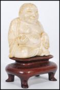A 19th century Chinese Ivory carved Buddha. The laughing Buddha seated in the lotus position and