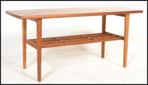 A vintage retro 20th Century Danish inspired coffee table, mahogany top raised on a teak wood frame,