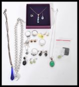 A selection of ladies jewellery to include a silver white metal ring set with a central sqaure cut