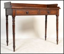 A Victorian mahogany writing table desk being raised on turned legs with twin drawers to the