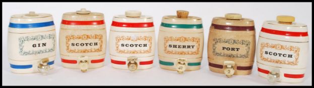 A selection of Wade collectable ceramic barrel decanters to include Scotch, Gin, Port and Sherry.