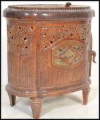 An early 20th century French enamel woodburner stove. Brown enamel colourway to the lozenge shaped