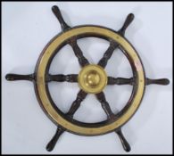 An early 20th century stained teak and brass bound ships wheel,with notation to the verso reading