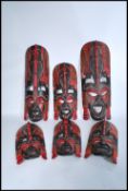 A group of 20th century graduating wooden African tribal wall masks of colourful decorative
