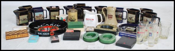 A large collection of vintage pub related breweriana items to include ashtrays, whisky water jugs,