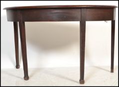 A 19th century mahogany large D-end / demi lune console hall table being raised on square tapered